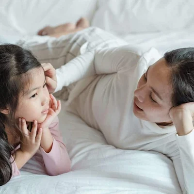 Mother and daughter bonding time on the bed