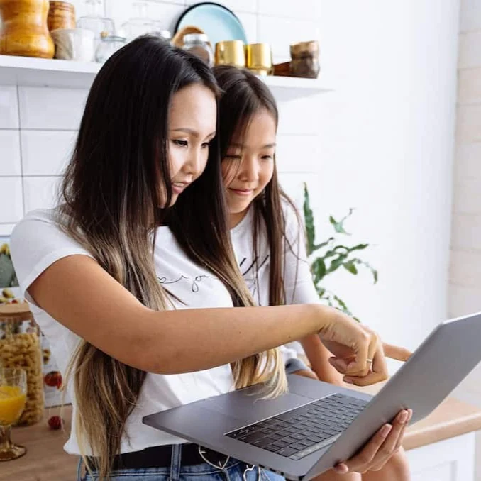 Mother and daughter looking for recipe