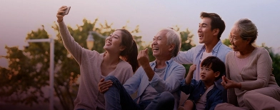 a family taking a selfie on the grass