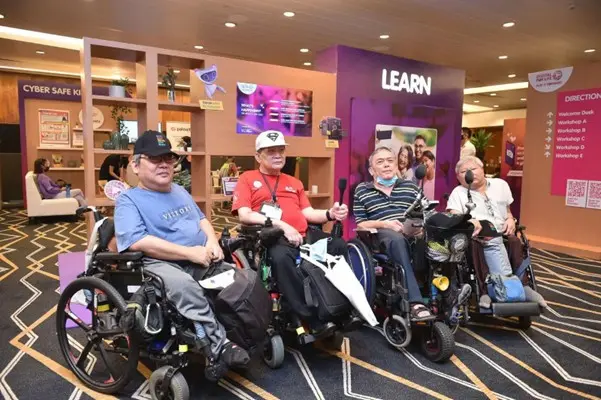 Four men seated in wheelchairs are seen to attend the DfL Festival in 2022