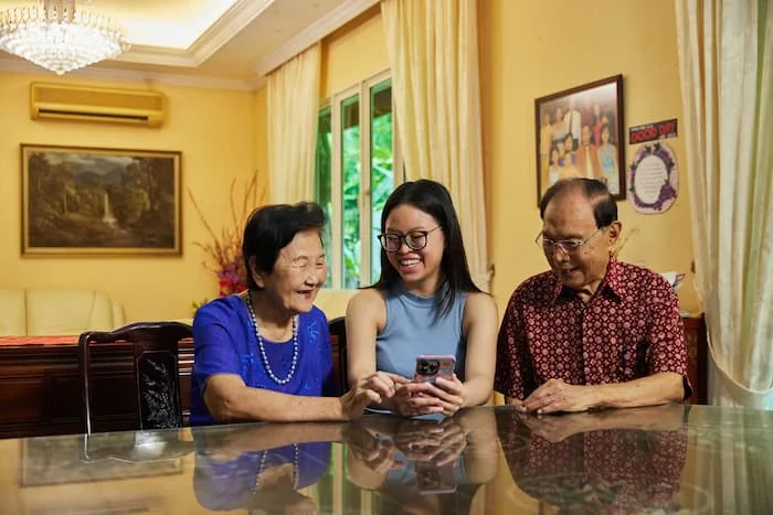 OSF Funded Project: A woman equips an elderly couple with digital skills under the BT Digital 2021, enhancing digital wellness