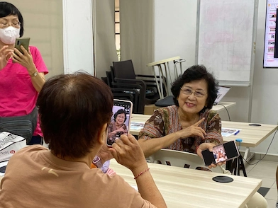 Two senior citizens interacting and laughing