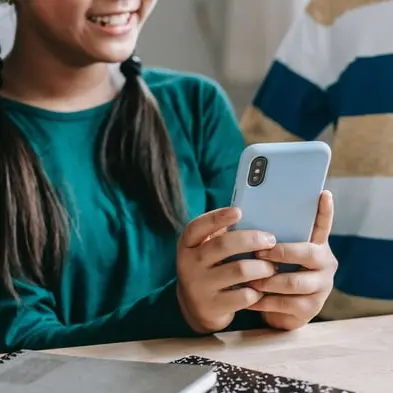 Sister and brother using phone