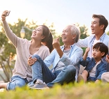 a family taking a selfie on the grass