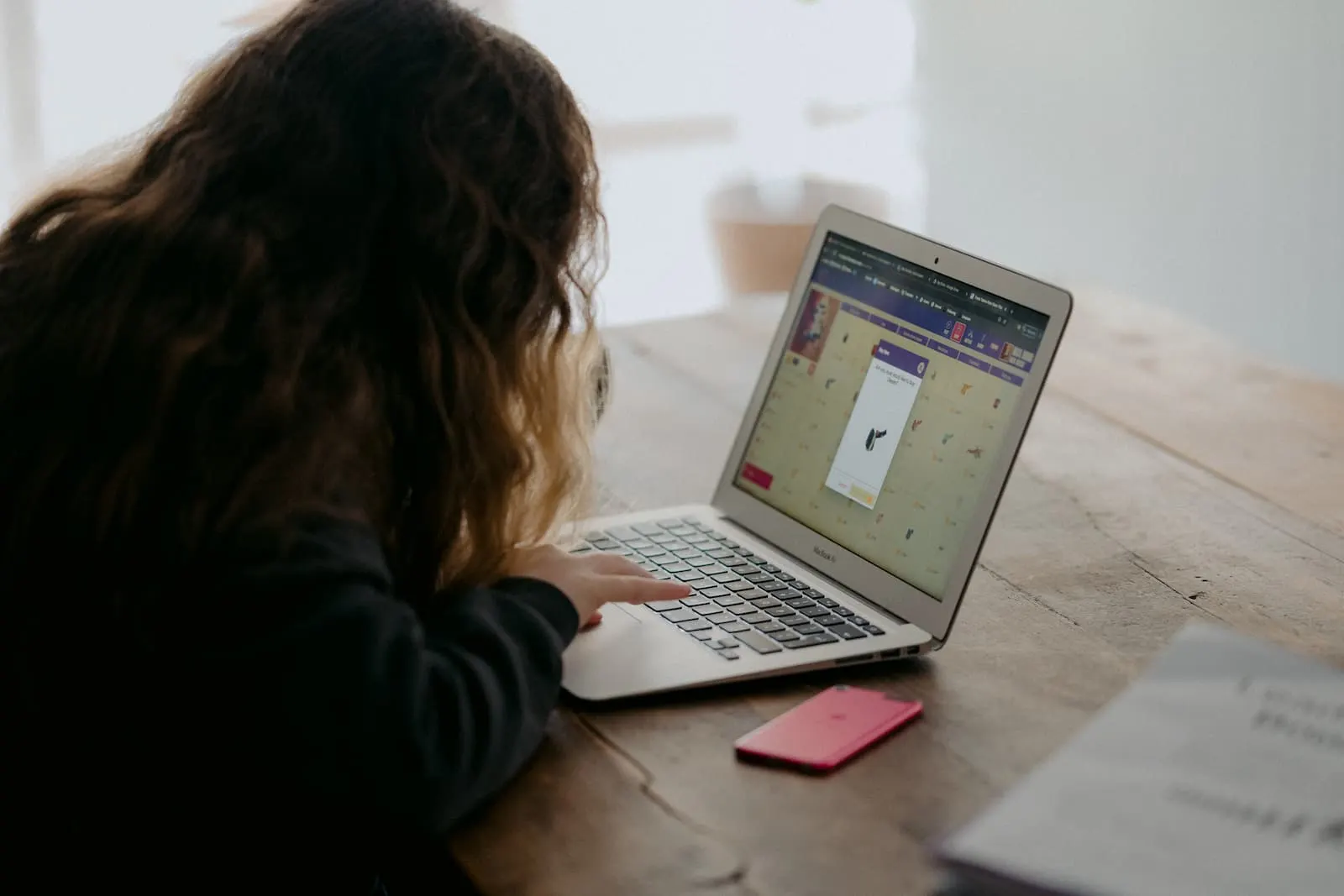 A lady browsing social media site on her laptop