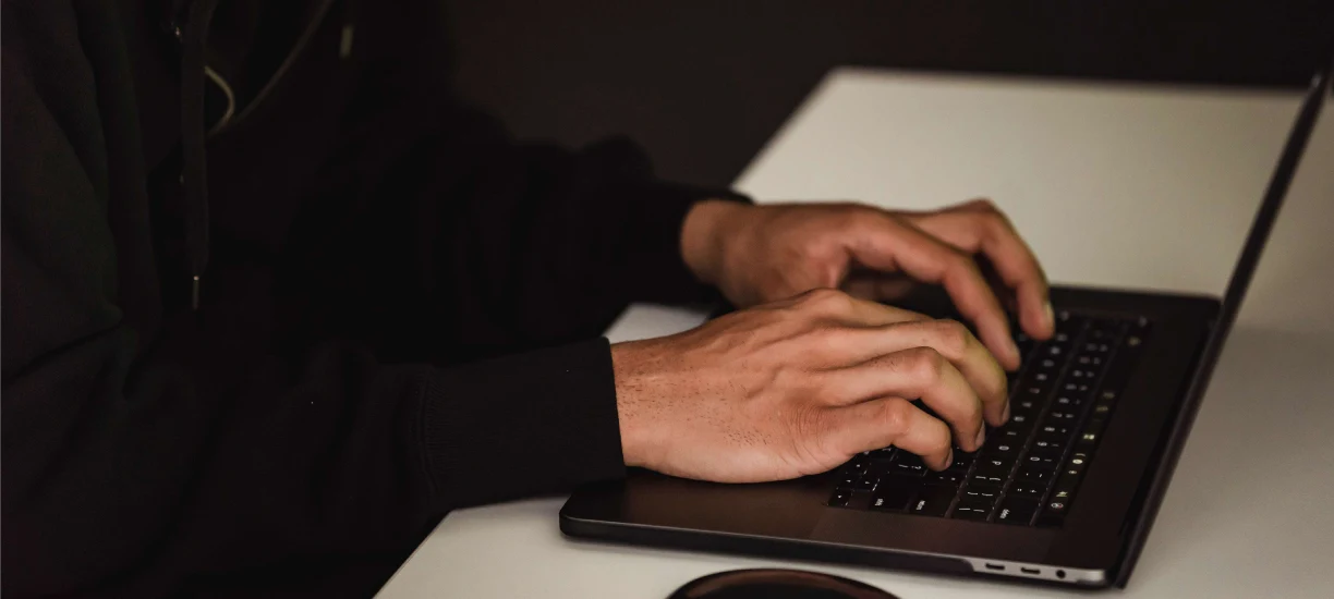 Pair of hands on the keyboard.